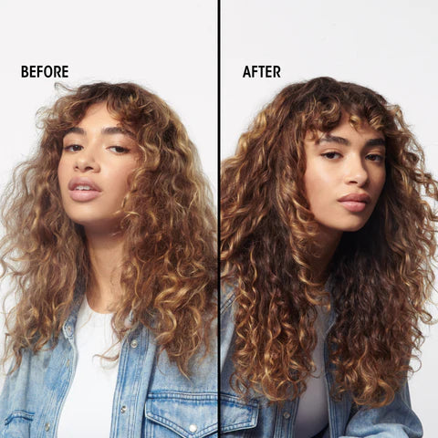 Before-and-after split comparison of a woman using Oribe Curl Gloss with long, curly brown hair, showing the hair texture and volume improved, likely demonstrating a hair product or treatment. She is wearing a light blue denim jacket over a white top against a plain white background.
