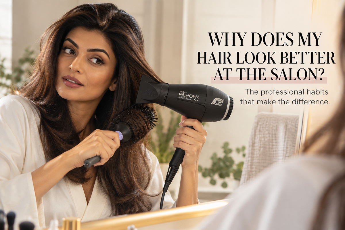 Woman blow-drying glossy brunette hair at home with a Parlux Alyon hairdryer and round brush.