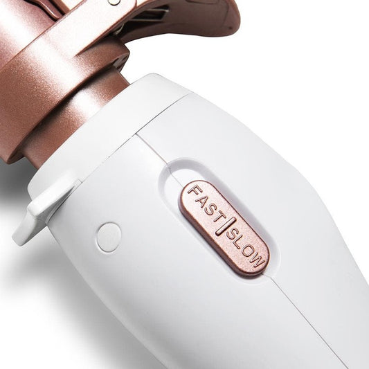 Close-up of Beachwaver curling iron handle showing rose gold FAST SLOW speed switch