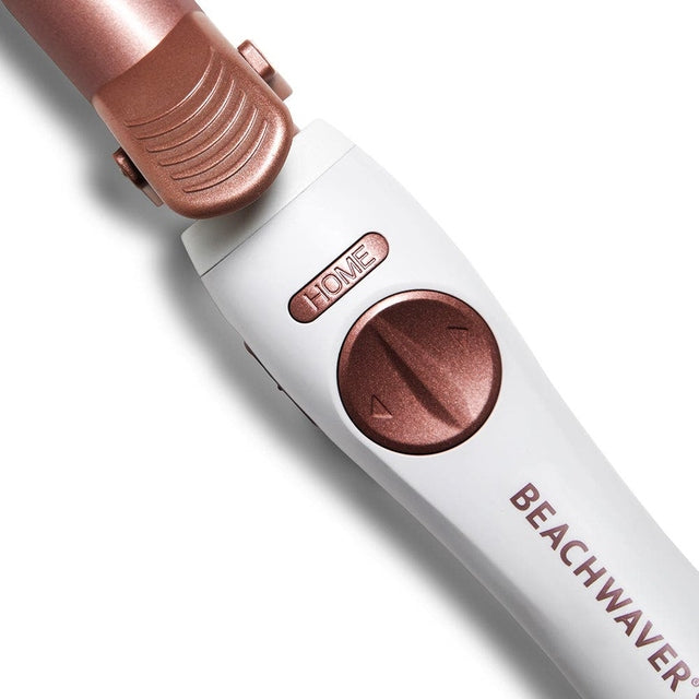 Close-up of Beachwaver S1.25 curling iron handle with rose gold rotation dial and HOME button