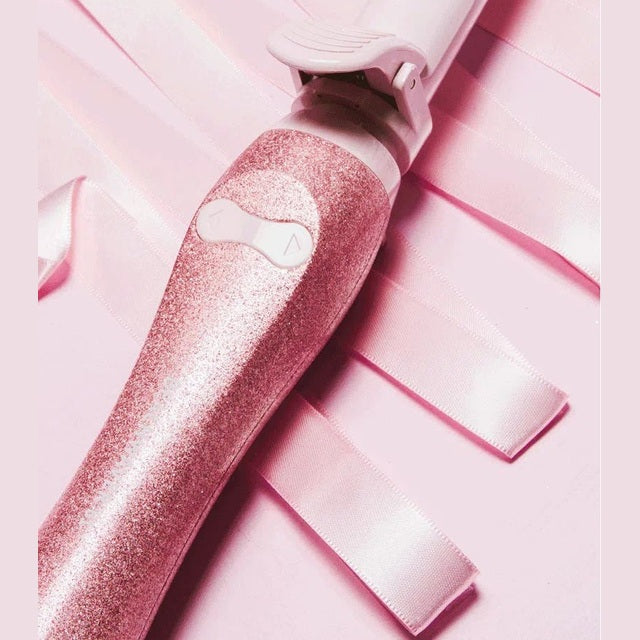 Pink sparkle Beachwaver S1 Glitter Holiday curling iron handle on pink ribbon background