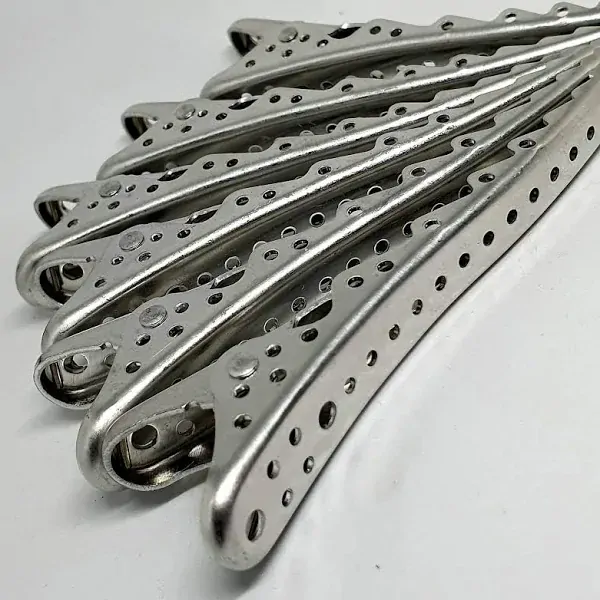 Angled view of Hi Lift Professional Super Clips, six silver metal vented hair clips fanned out