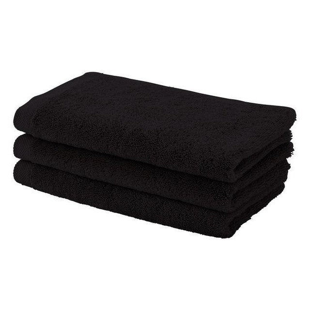 Three folded deluxe black 100% cotton salon towels shown in a neat stack