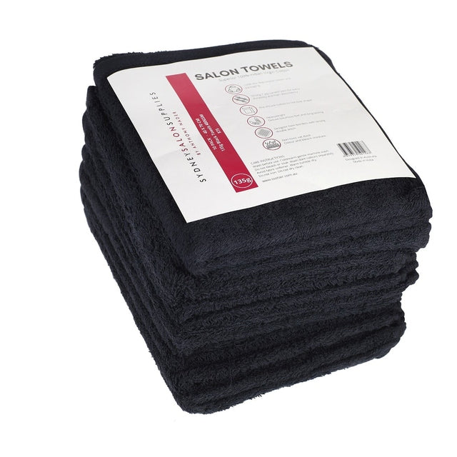 Pile of folded black 100% cotton salon towels with product label on top, 40x70cm