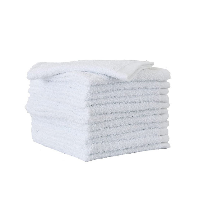 Side view of ten white cotton face washers stacked with one cloth on top