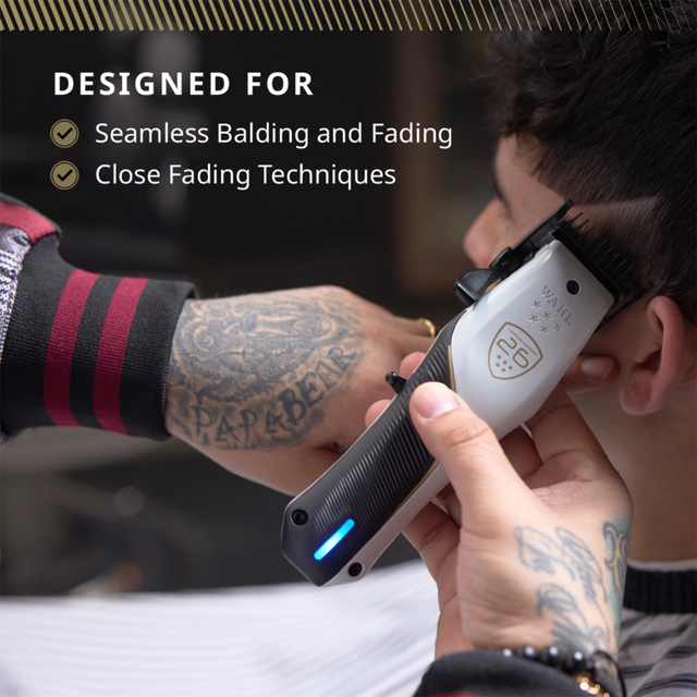 Barber using Wahl 5-Star Vapor CE clipper to create a close fade on a client
