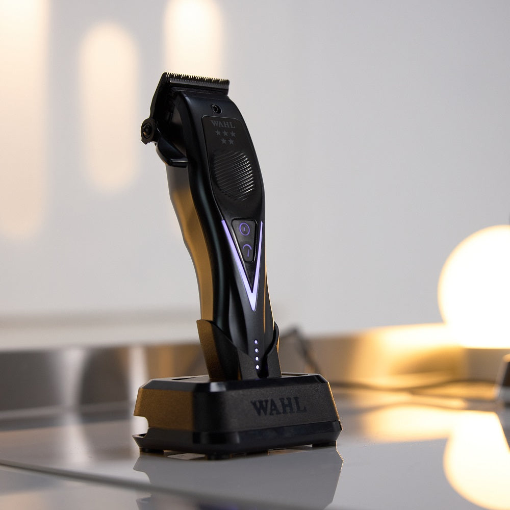 Wahl Vapor Switch cordless clipper standing upright on charging base on counter