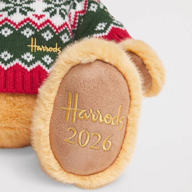 Close-up of Harrods 2026 Christmas bear paw with gold Harrods 2026 embroidery and patterned jumper
